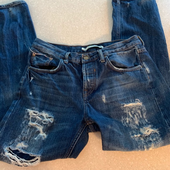 distressed dark blue jeans